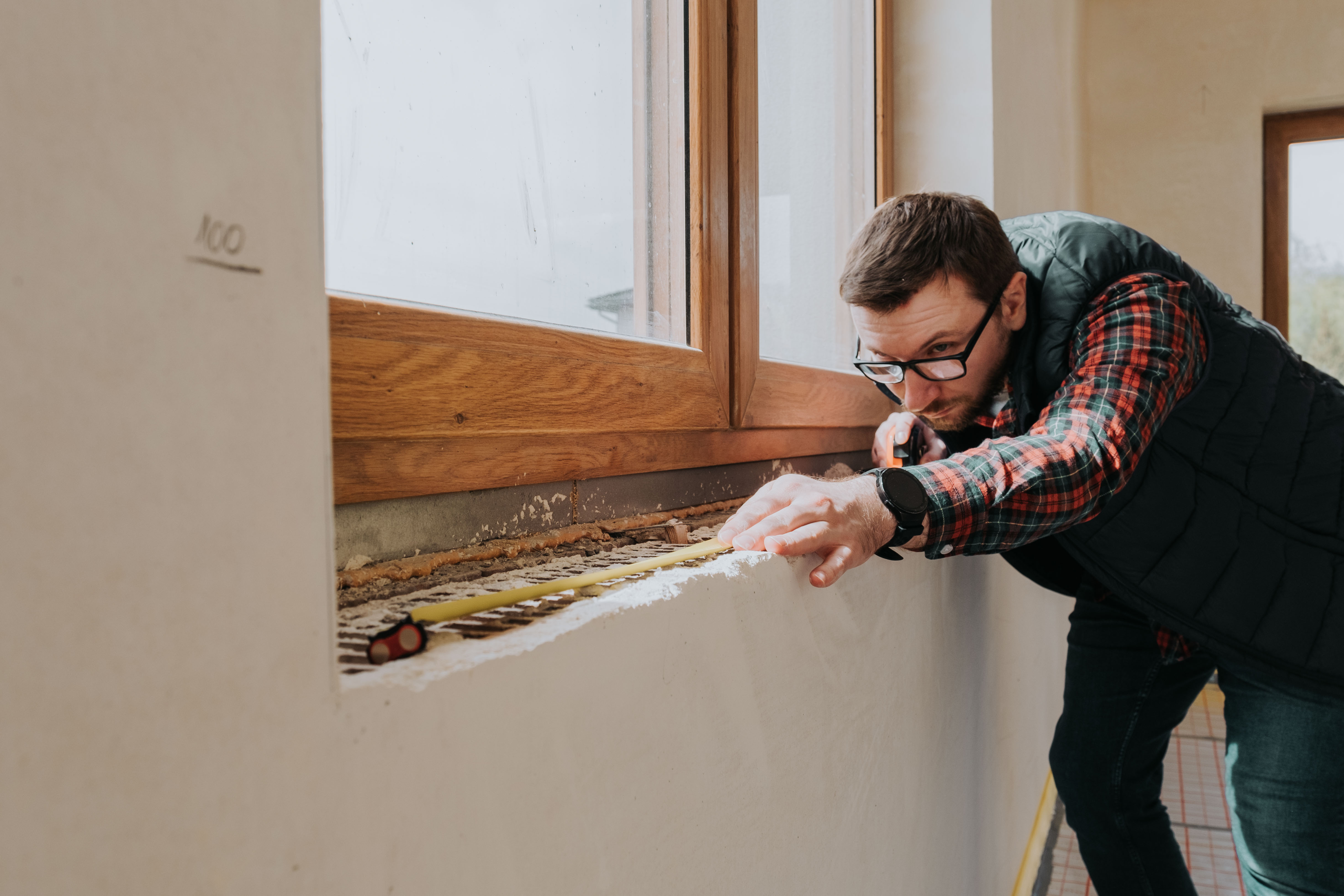 carpenter-measuring-window-ledge-in-new-