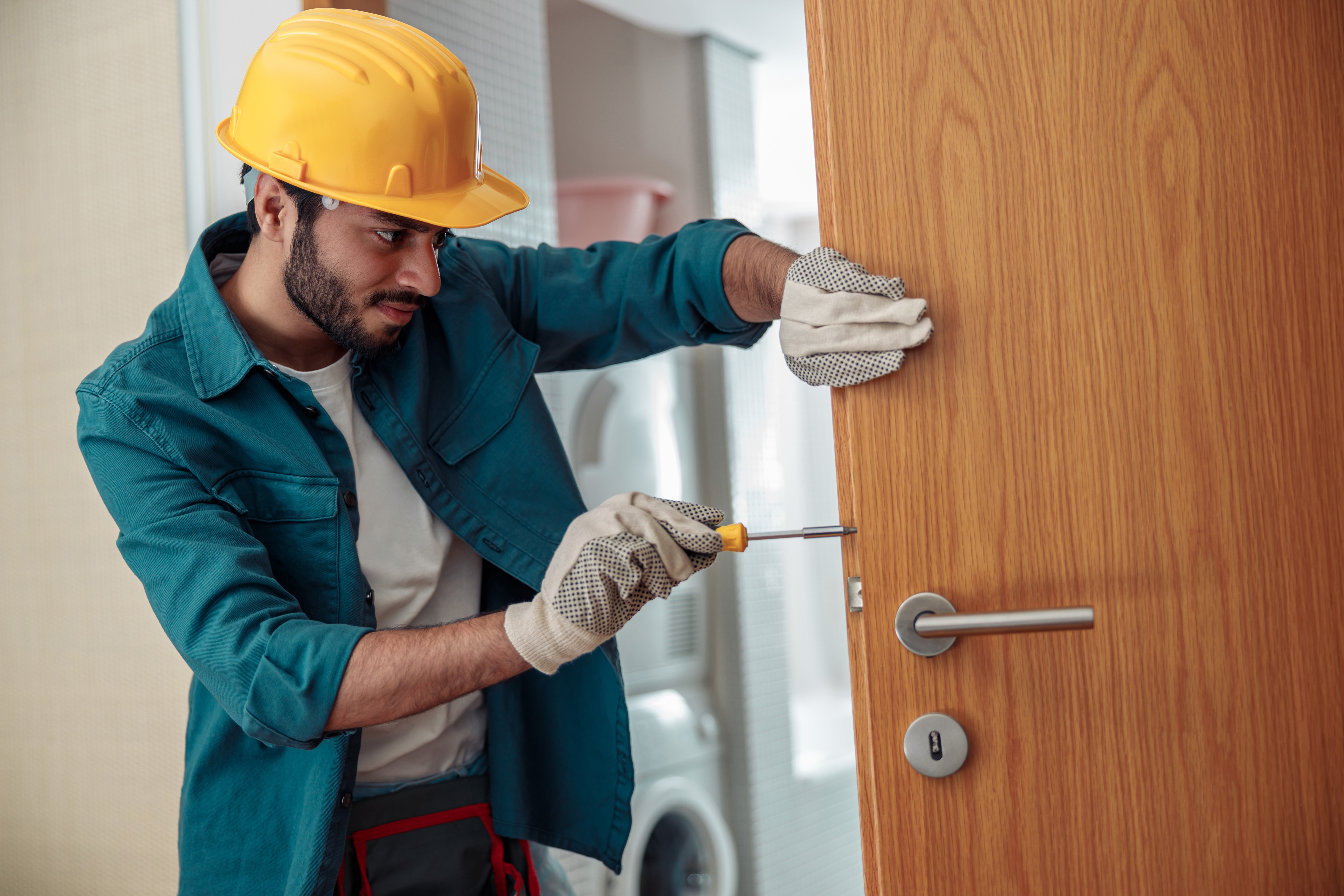 locksmith-workman-in-uniform-installing-door-knob-2023-01-05-00-20-11-utc.jpg