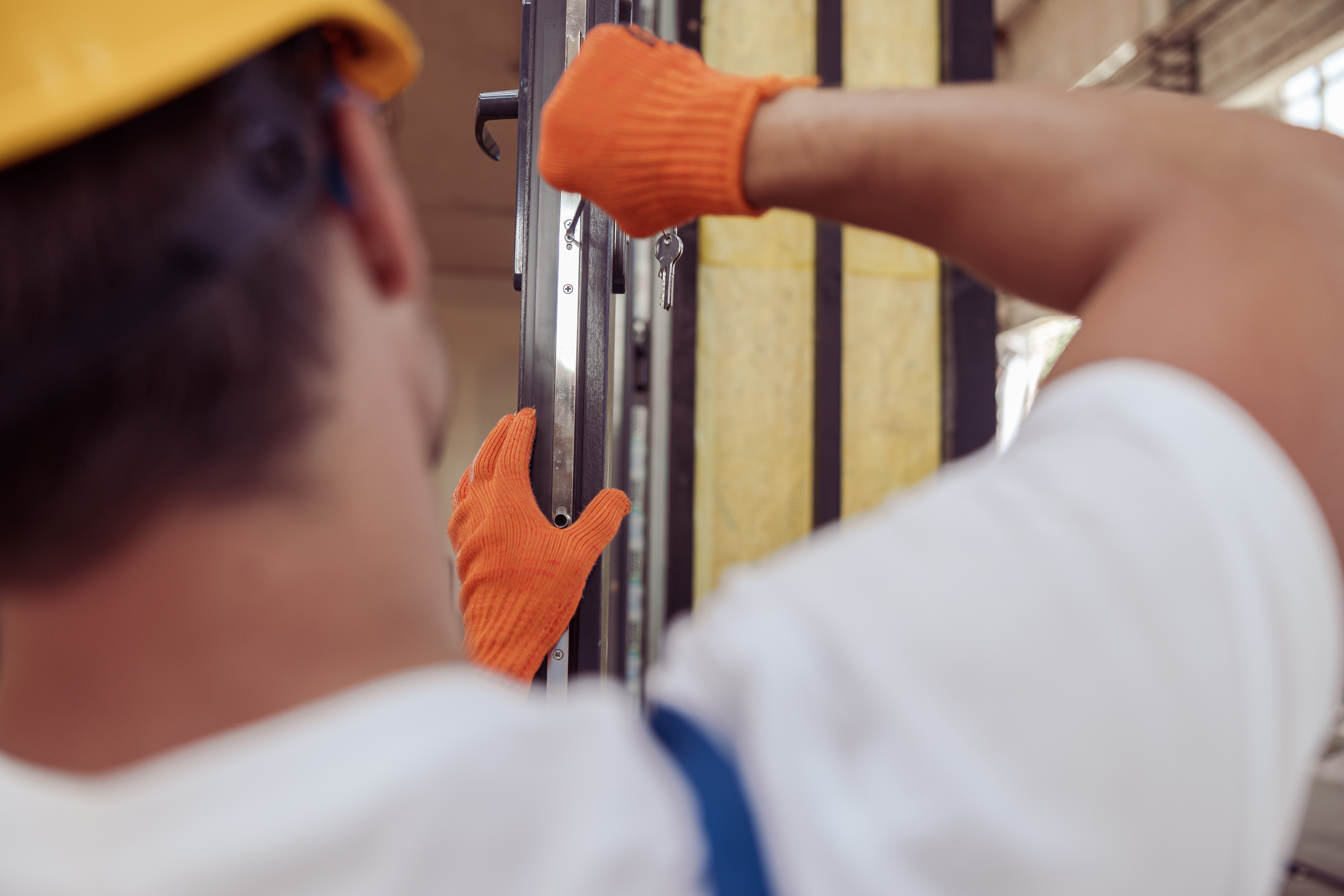 male-worker-repairing-door-in-building-under-const-2021-12-09-21-20-34-utc.jpg